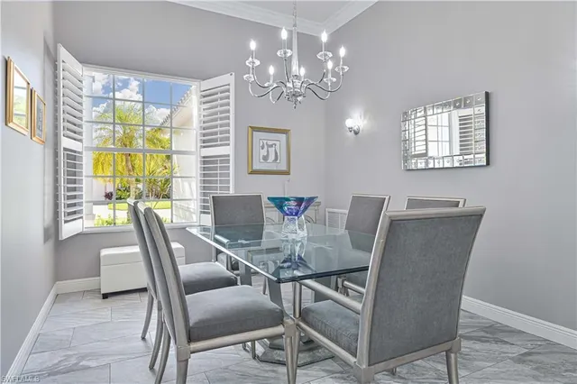 a view of a dining room with furniture and chandelier