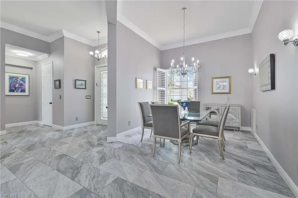 a view of a dining room with furniture and chandelier