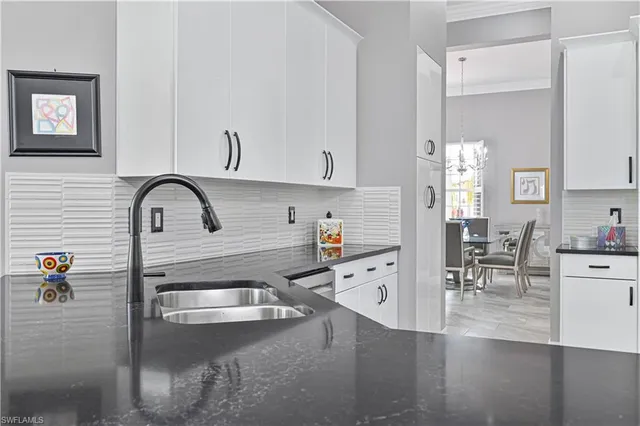 a kitchen with cabinets stainless steel appliances and a sink