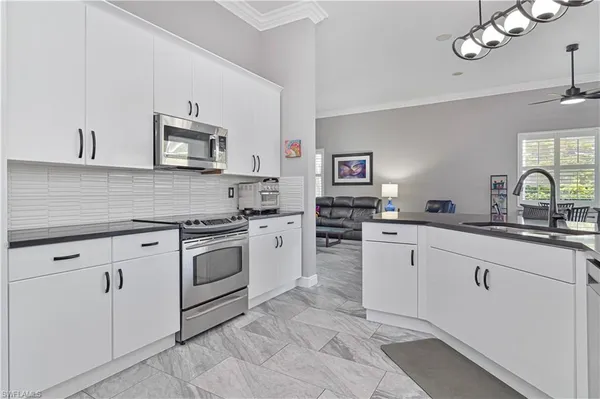 a kitchen with cabinets stainless steel appliances and a sink