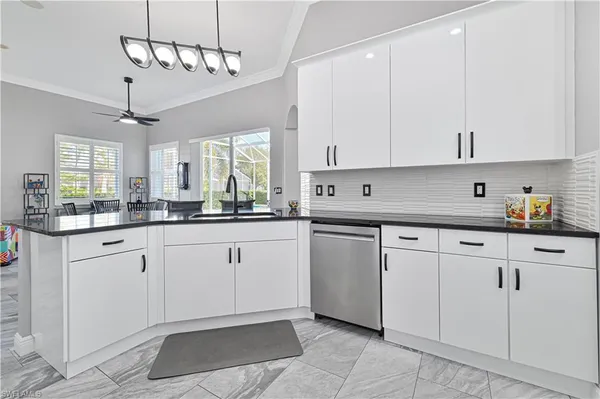 a kitchen with cabinets and window