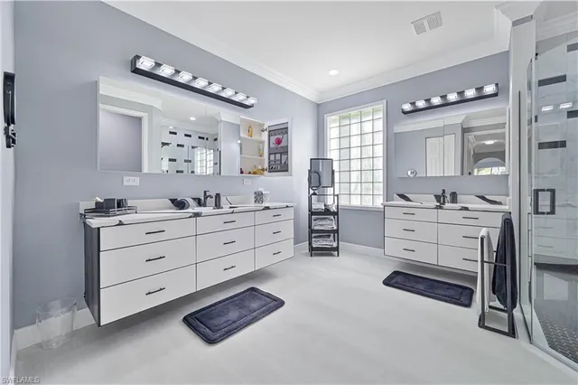 a bathroom with a sink vanity and mirror