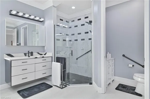 a bathroom with a double vanity sink mirror and toilet