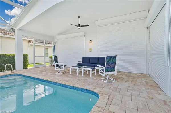 a room with furniture a flat screen tv and a table