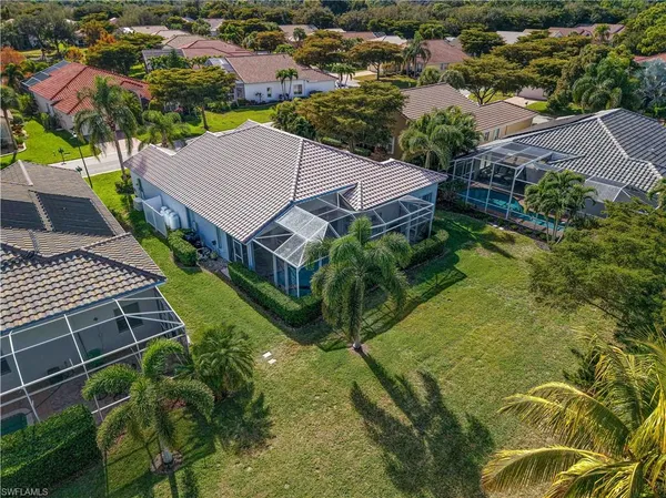 an aerial view of residential houses with yard
