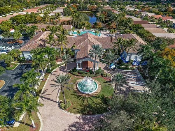 an aerial view of a residential houses with outdoor space and trees