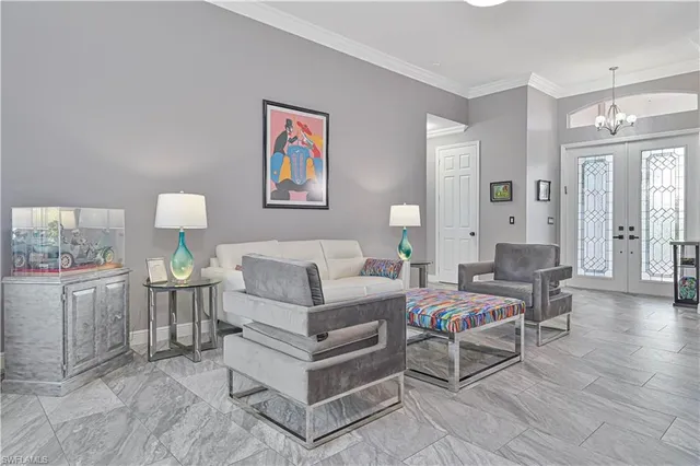 a living room with furniture and a dining table