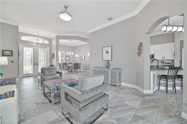 a living room with furniture and a dining table