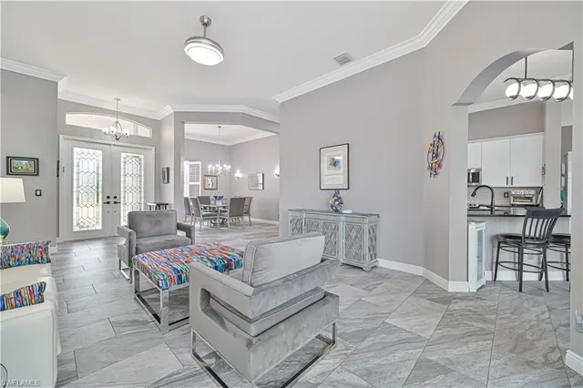 a view of a dining room with furniture and a chandelier