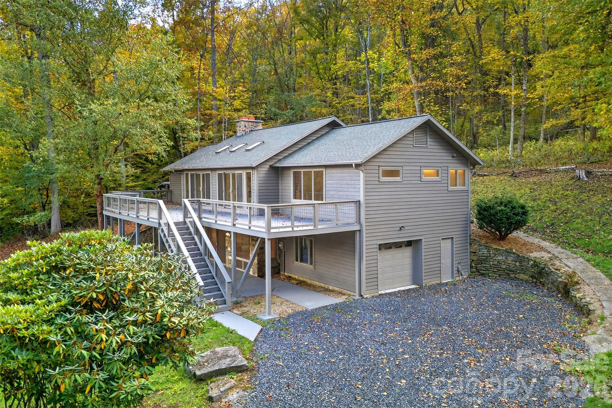575 Croft Way Bakersville, NC 28705 - Photo 1 of 38 a front view of a house with a yard and trees