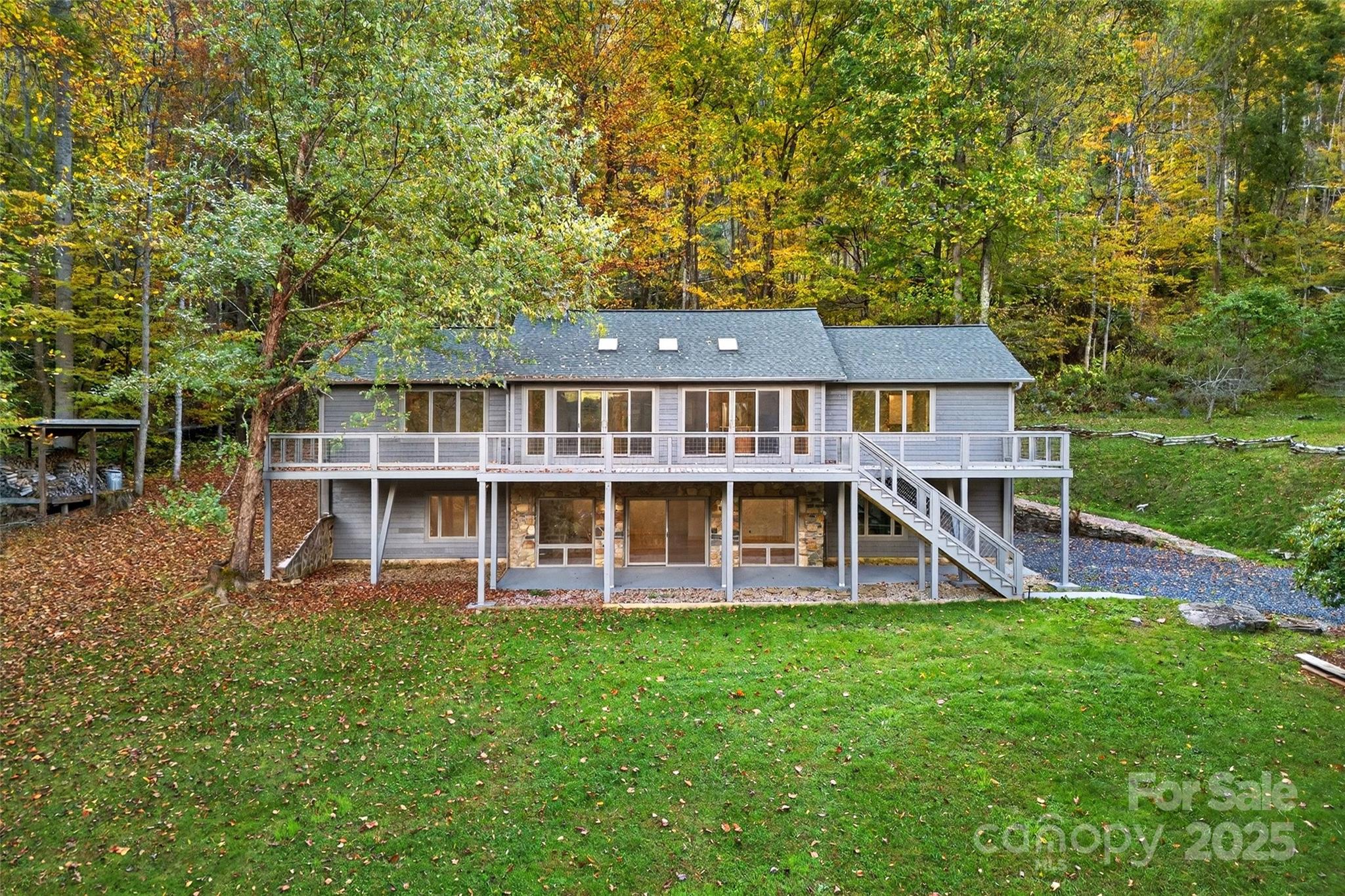 a view of a house with pool and a yard