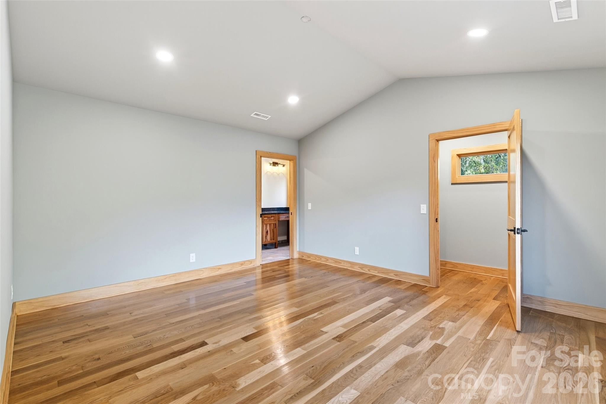 575 Croft Way Bakersville, NC 28705 - Photo 11 of 38 an empty room with wooden floor and windows