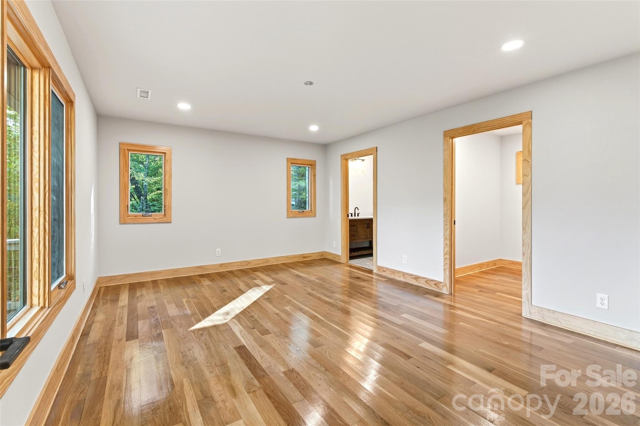 575 Croft Way Bakersville, NC 28705 - Photo 17 of 38 a view of an empty room with wooden floor and a window