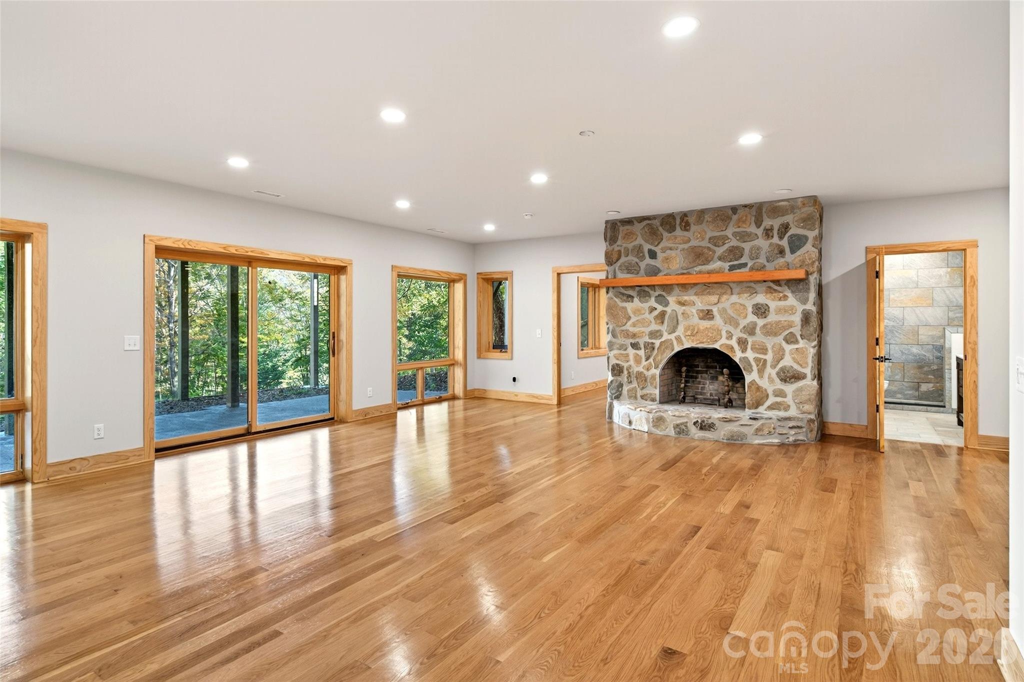 575 Croft Way Bakersville, NC 28705 - Photo 25 of 38 a view of empty room with wooden floor and fireplace
