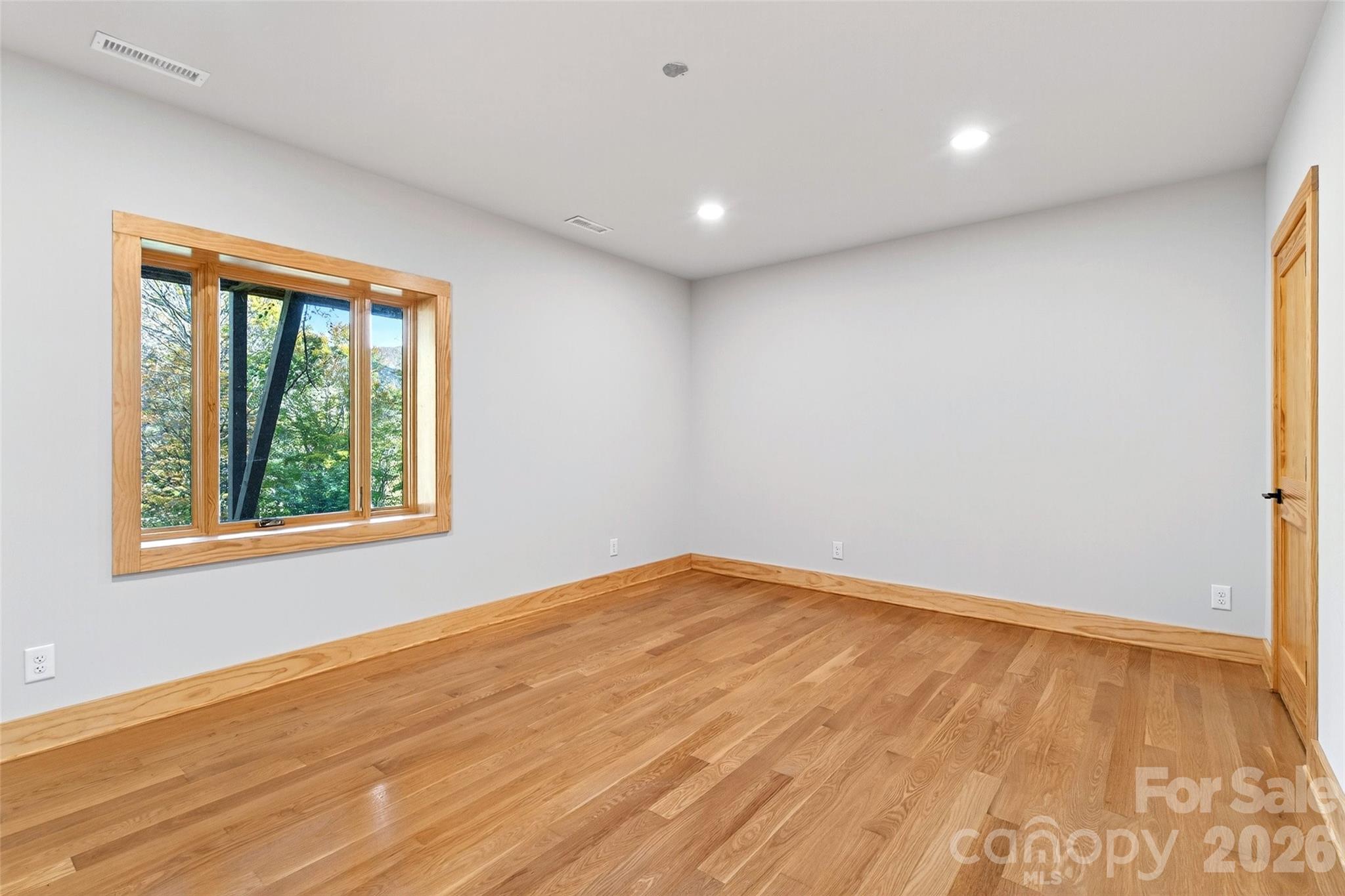 575 Croft Way Bakersville, NC 28705 - Photo 29 of 38 a view of empty room with wooden floor and fan