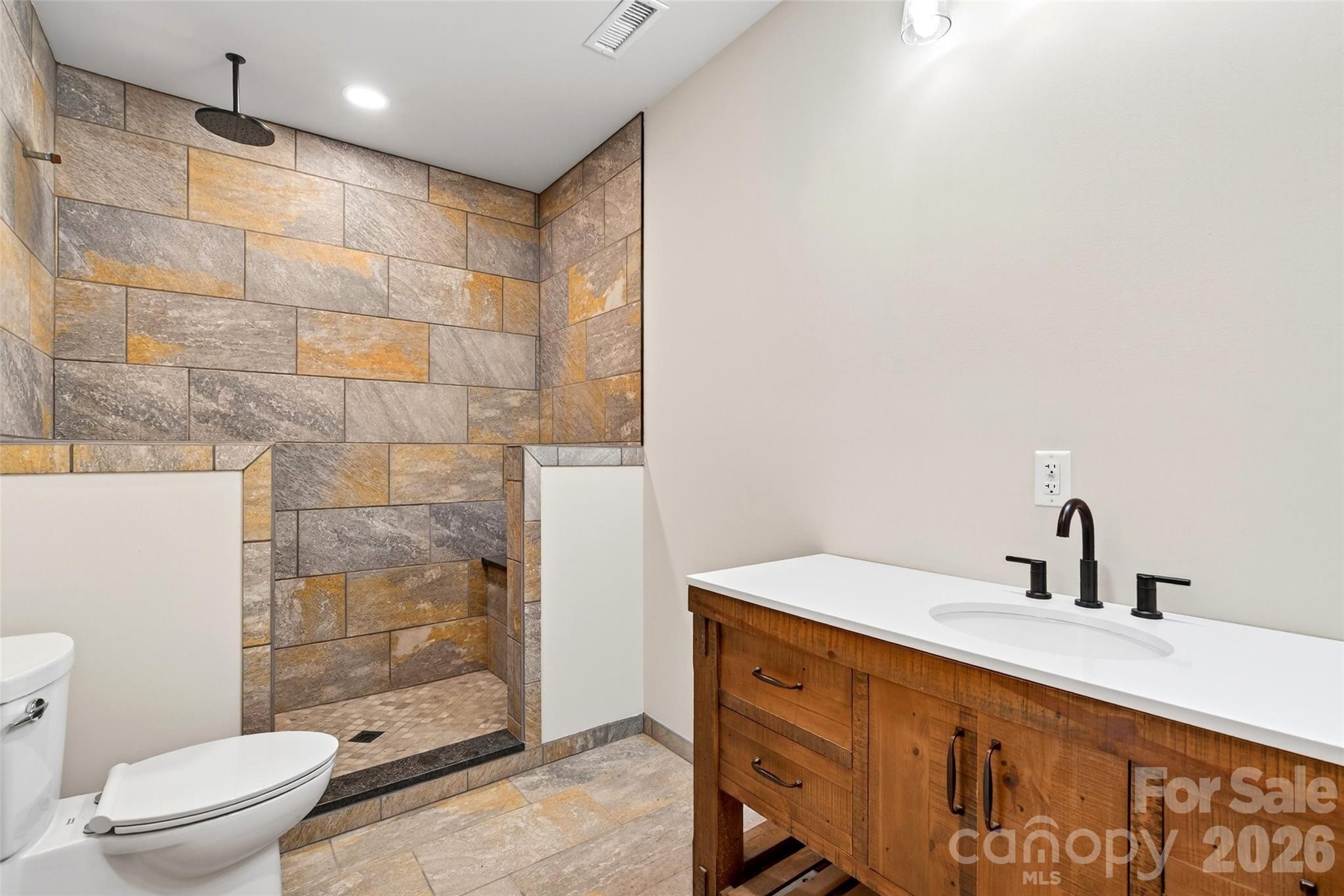 575 Croft Way Bakersville, NC 28705 - Photo 31 of 38 a bathroom with a sink a toilet and shower