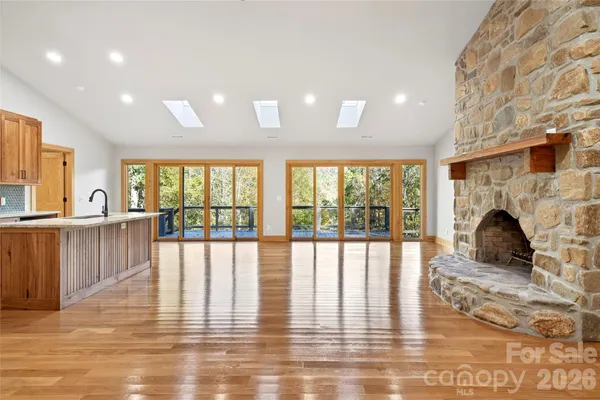 a view of a living room with hardwood floor and a large window