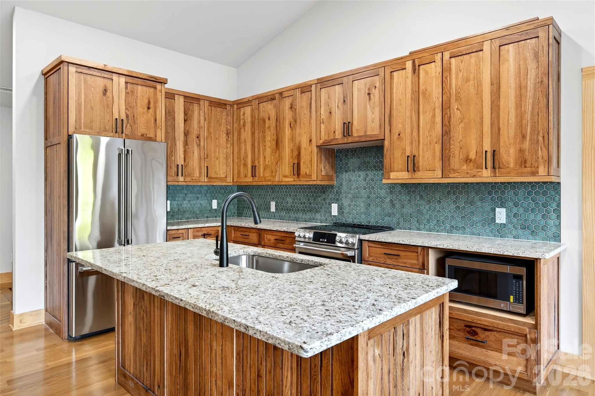 575 Croft Way Bakersville, NC 28705 - Photo 7 of 38 a kitchen with stainless steel appliances granite countertop a kitchen island a stove a sink dishwasher and cabinets with wooden floor