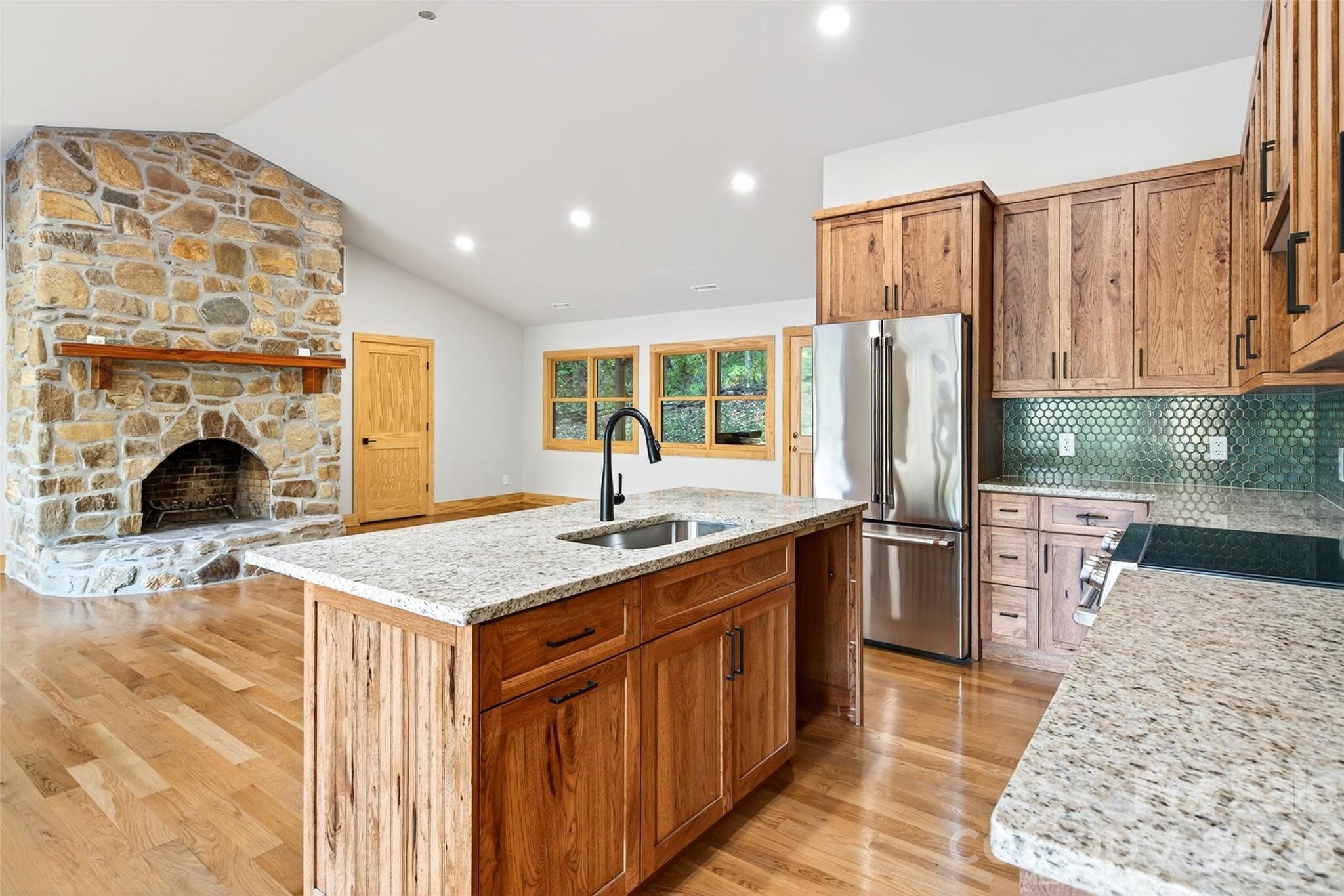 575 Croft Way Bakersville, NC 28705 - Photo 10 of 38 a kitchen with stainless steel appliances granite countertop a sink stove and refrigerator