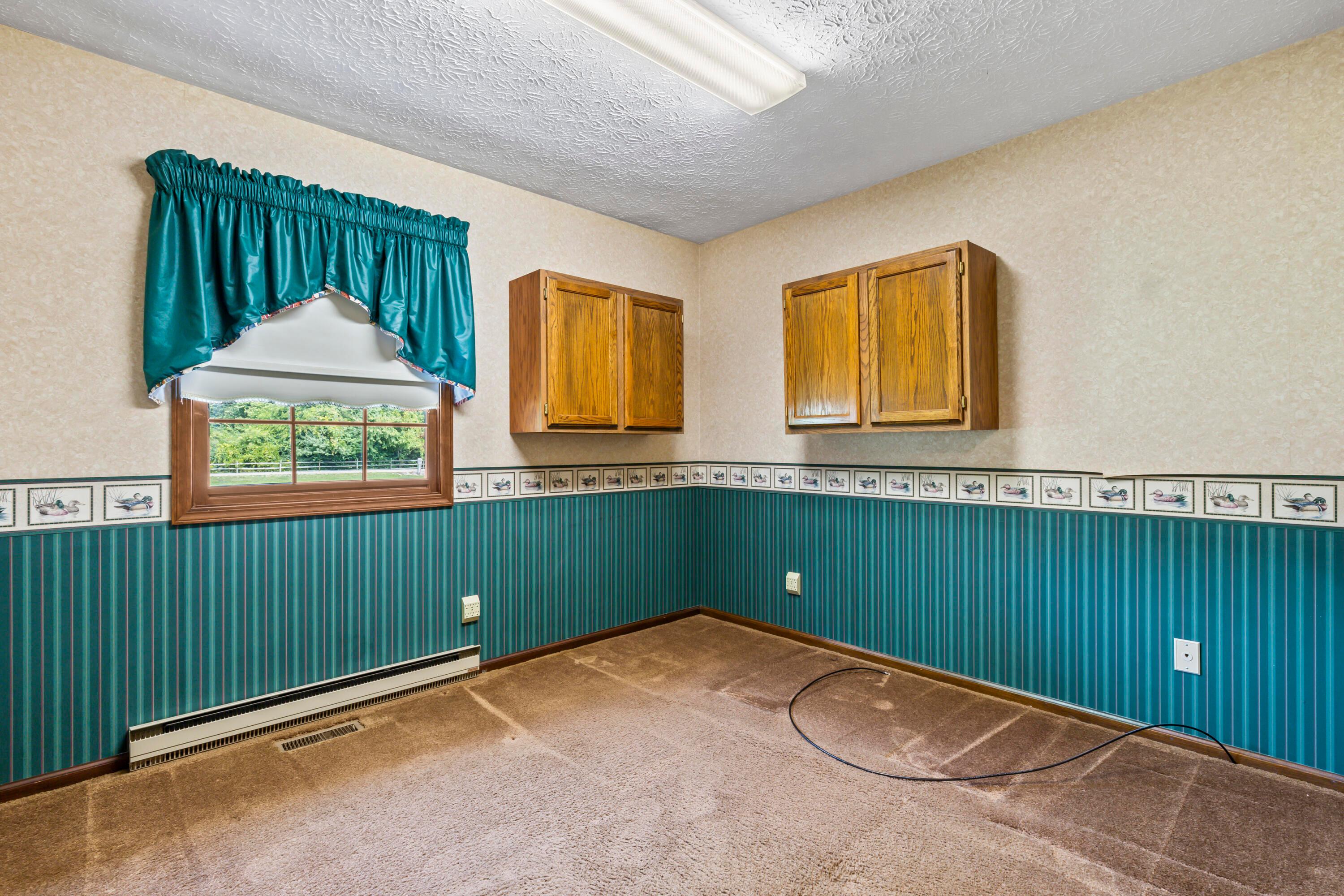 5764 Cheshire Road Galena, OH 43021 - Photo 27 of 59 • Mauve carpet
• Papered walls
• Ceiling light
• Wall cabinets
• Open lighted closet