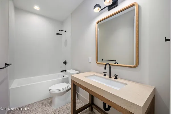 an aerial view of a house with a garden and a yard