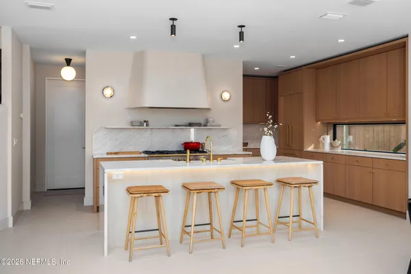 a kitchen with stainless steel appliances kitchen island granite countertop a sink and cabinets