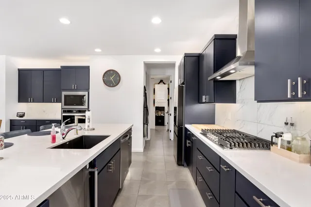 a kitchen with a sink stove and refrigerator