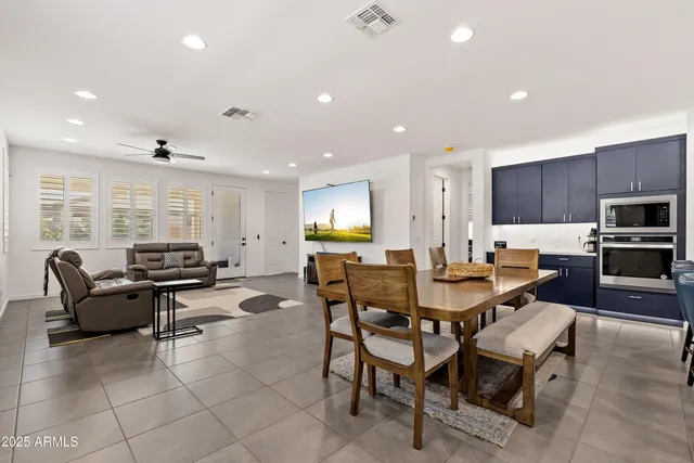a living room with fireplace furniture and a large window