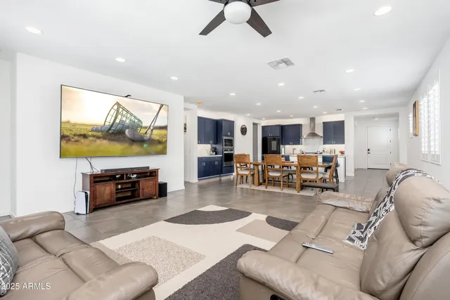 a living room with furniture and kitchen view