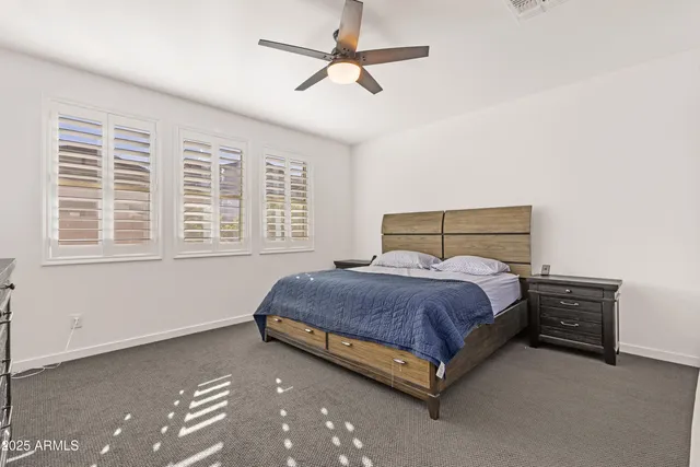a spacious bedroom with a bed and a chandelier