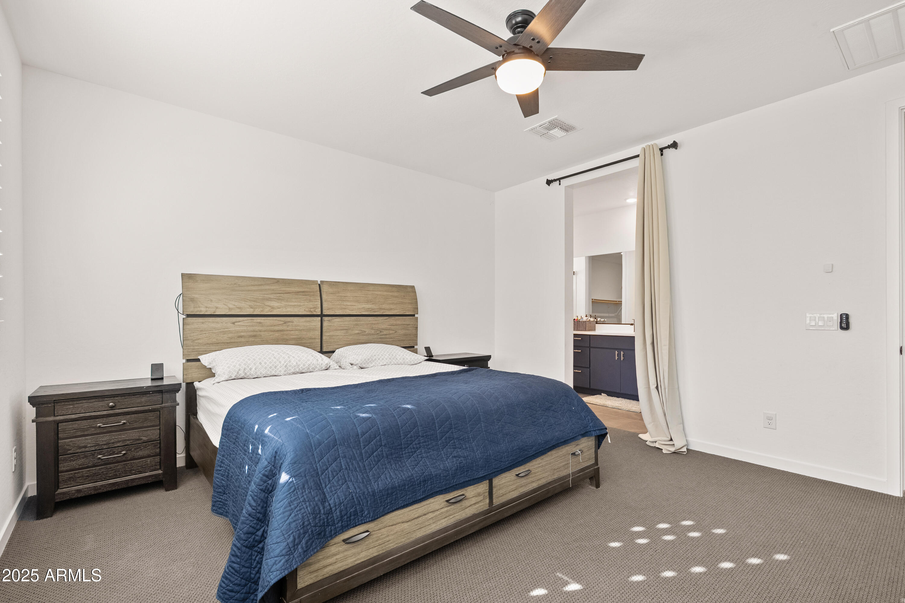 21357 East Macaw Drive Queen Creek, AZ 85142 - Photo 17 of 48 a bedroom with a bed and a chandelier