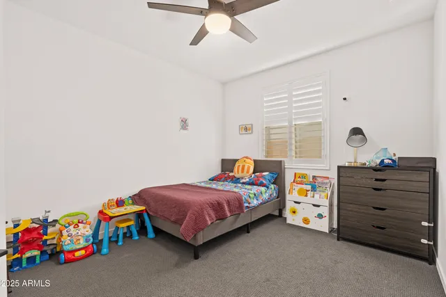 a bedroom with a bed and a dresser in it