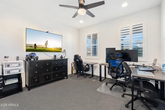a view of a workspace with furniture and a window
