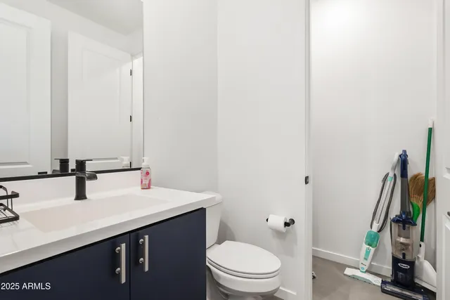 a bathroom with a sink a toilet and a mirror