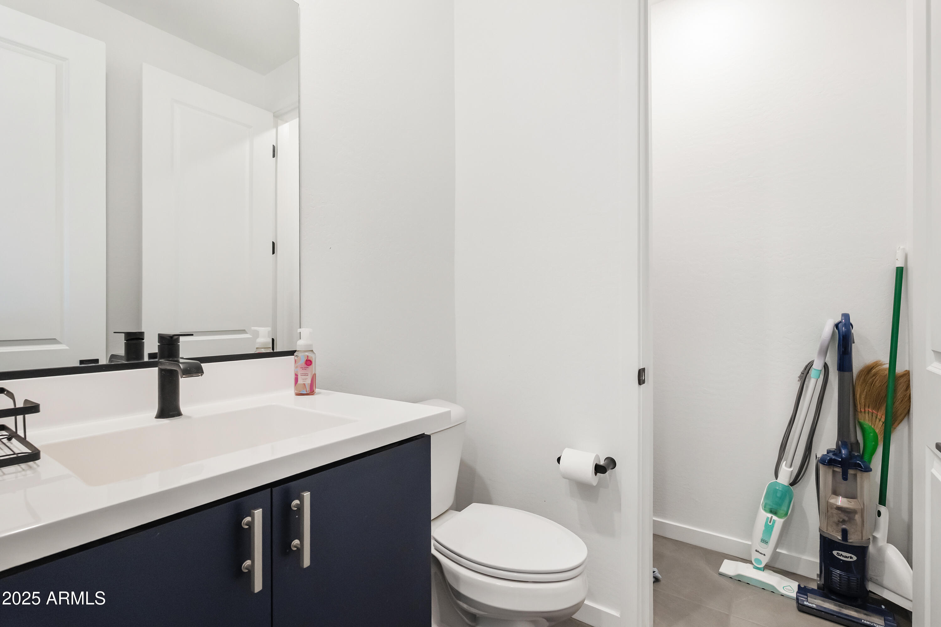21357 East Macaw Drive Queen Creek, AZ 85142 - Photo 24 of 48 a bathroom with a sink a toilet and a mirror