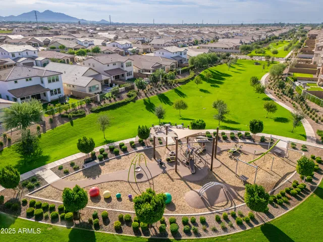 an aerial view of a house with a yard and lake view
