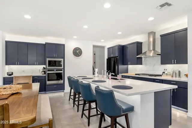 a kitchen with stainless steel appliances kitchen island granite countertop a sink and cabinets