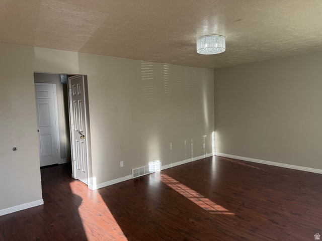 1563 South 600 East Springville, UT 84663 - Photo 4 of 30 Spacious room featuring wood-finish flooring, neutral-toned walls, and white baseboards