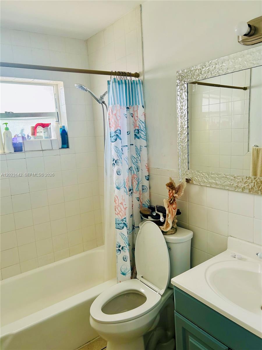 3410 Southwest 89th Court Miami, FL 33165 - Photo 14 of 18 a white toilet sitting next to a bath tub