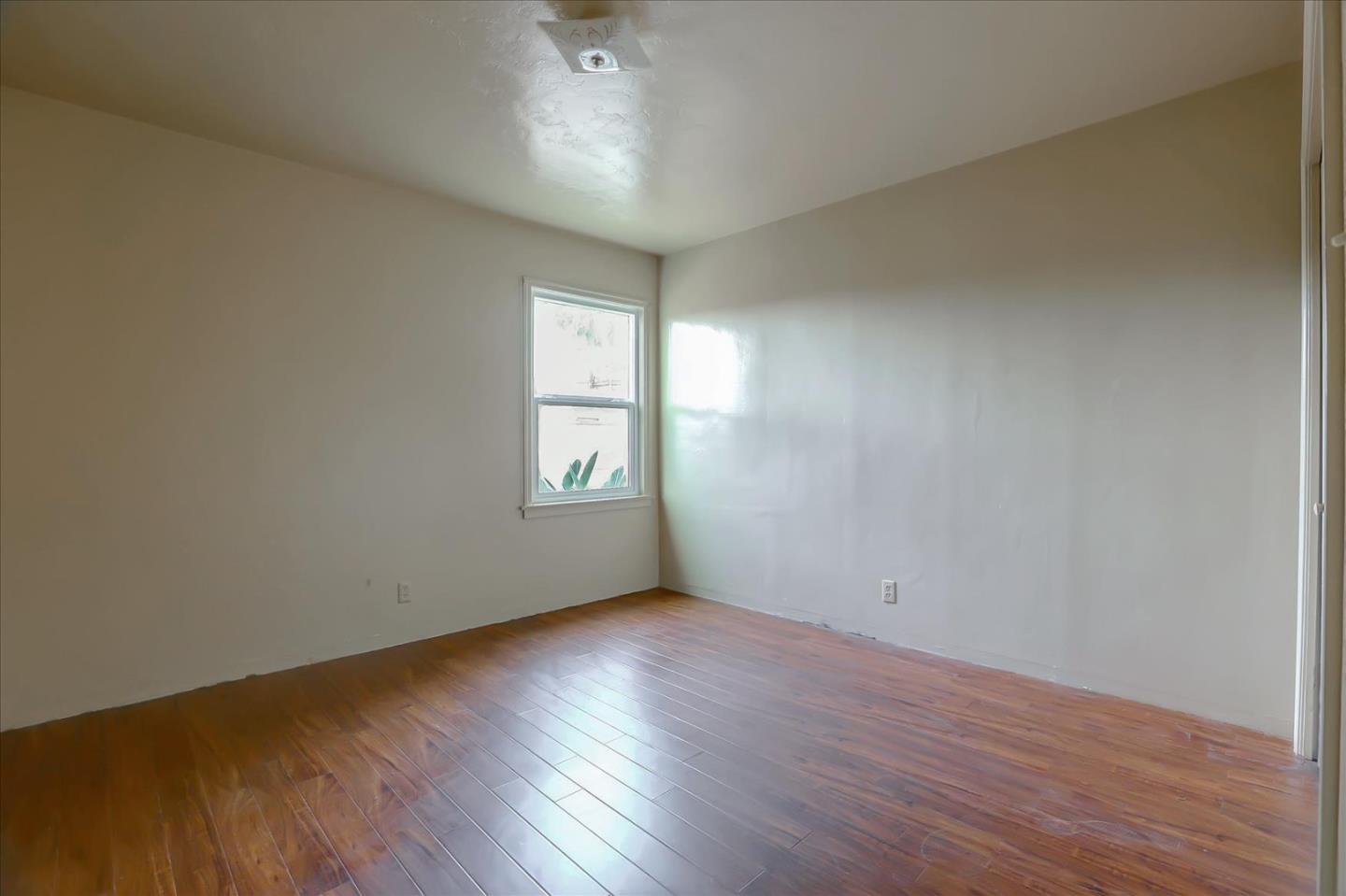 10150 Clayton Road San Jose, CA 95127 - Photo 18 of 61 an empty room with wooden floor and windows