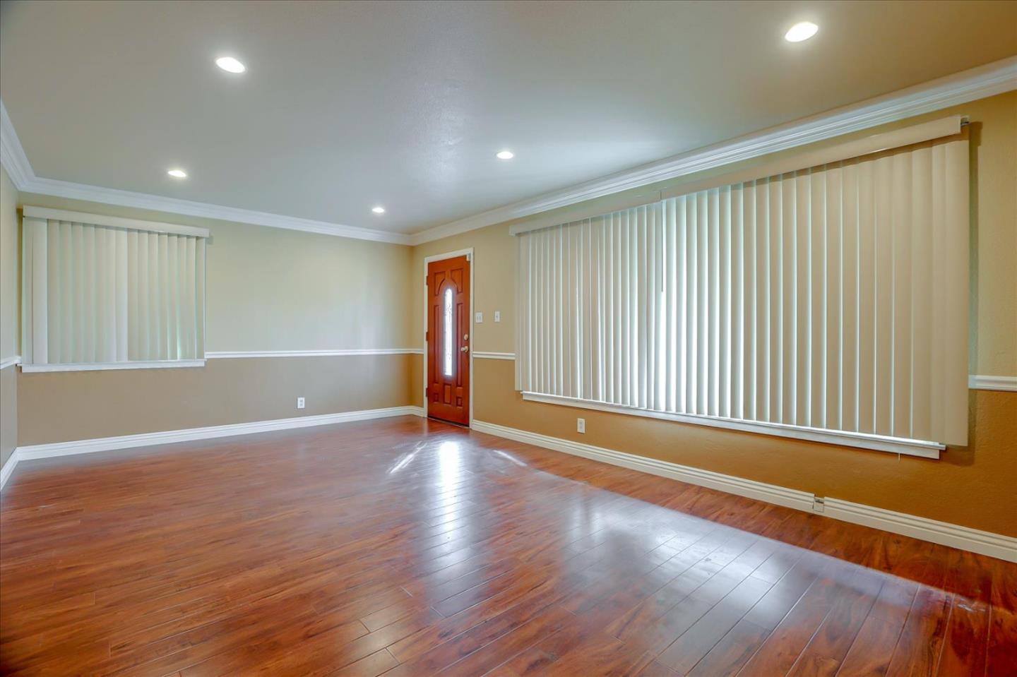 10150 Clayton Road San Jose, CA 95127 - Photo 5 of 61 a view of an empty room with wooden floor and a window