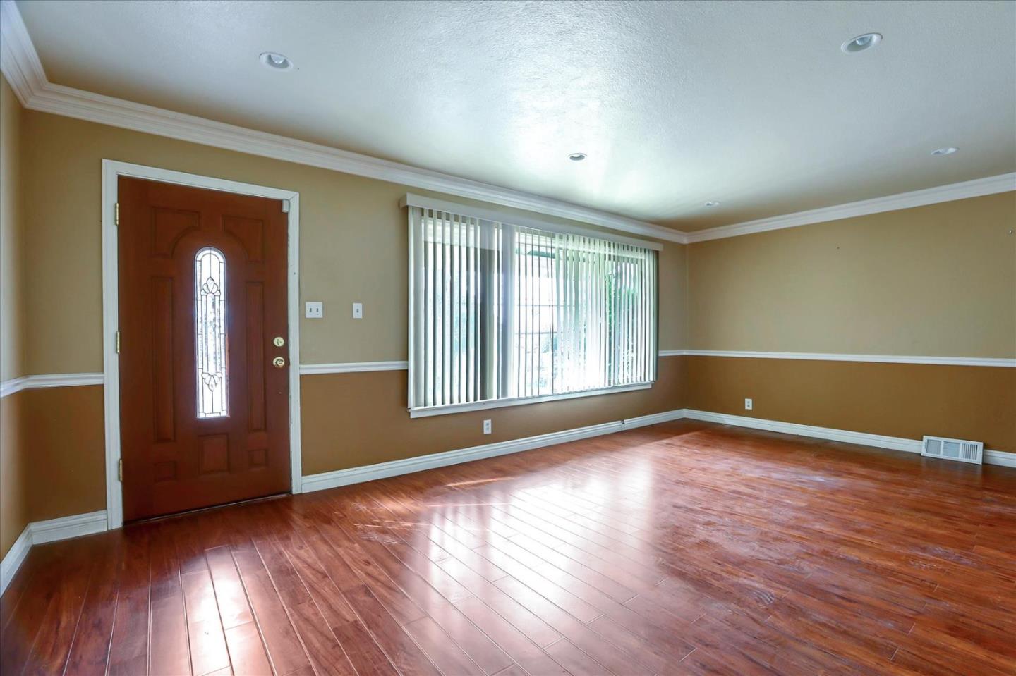 10150 Clayton Road San Jose, CA 95127 - Photo 6 of 61 a view of an empty room with wooden floor and a window