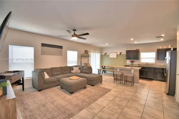 a living room with furniture and kitchen view