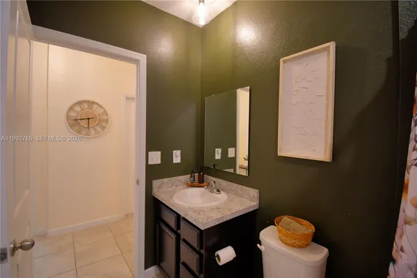 a bathroom with a sink mirror and toilet