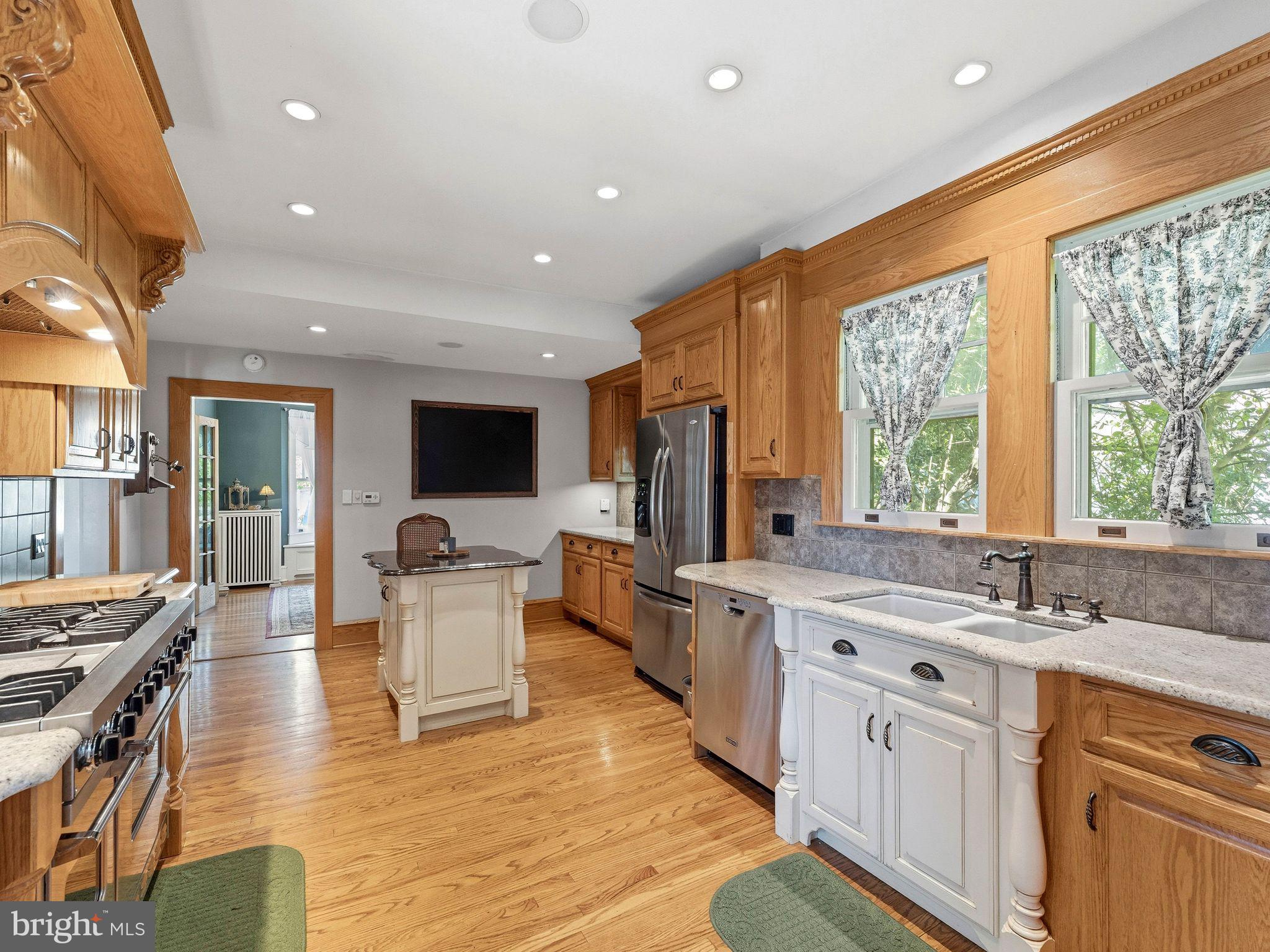 229 North Main Street Woodstown, NJ 08098 - Photo 25 of 74 a large kitchen with stainless steel appliances granite countertop a lot of counter space and wooden floors