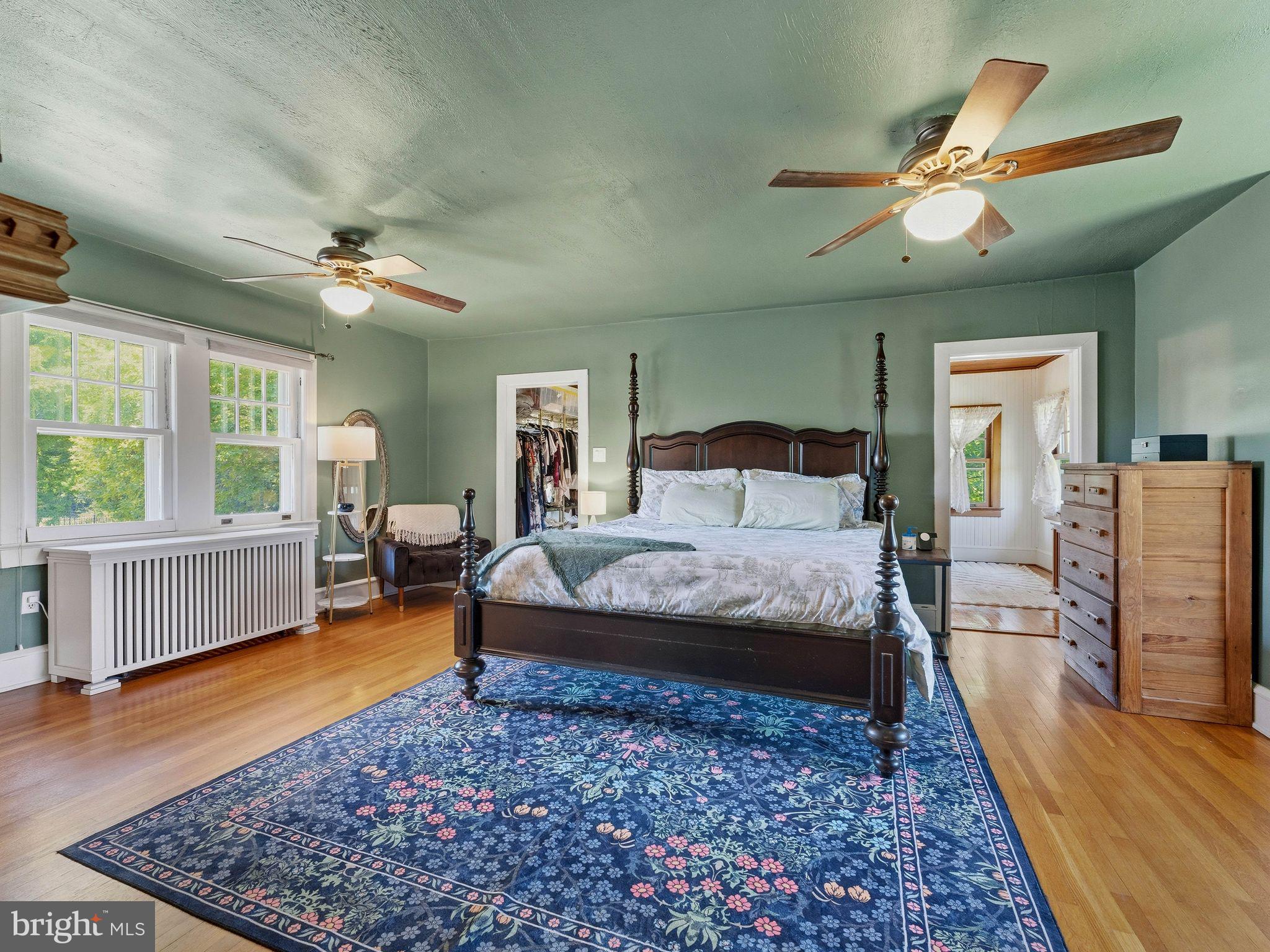 229 North Main Street Woodstown, NJ 08098 - Photo 31 of 74 a bedroom with a large bed a chandelier and next to a window