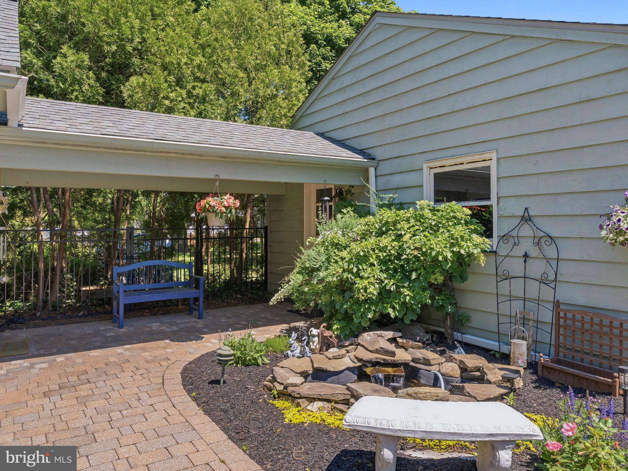 229 North Main Street Woodstown, NJ 08098 - Photo 51 of 74 a view of a patio with table and chairs potted plants and floor to ceiling window and wooden fence