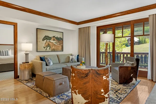 a living room with furniture large window and flat screen tv