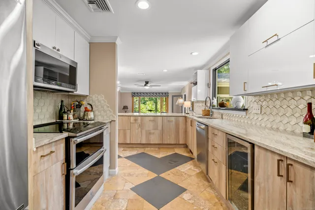 a kitchen with stainless steel appliances granite countertop a stove and a sink