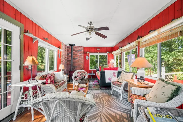 a living room with furniture a fireplace and a large window